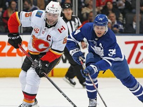 LEAFS LOSE IN SHOOTOUT Calgary Flames' Mark Giordano, left, gets a shot away against a checking Auston Matthews of the Toronto Maple Leafs on Thursday at Scotiabank Arena in Toronto. The Flames won 2-1 in a shootout. Claus Andersen/Getty Images TORONTO, ON - JANUARY 16: Mark Giordano #5 of the Calgary Flames gets a shot away against a checking Auston Matthews #34 of the Toronto Maple Leafs during an NHL game at Scotiabank Arena on January 16, 2020 in Toronto, Ontario, Canada. The Flames defeated the Maple Leafsd 2-1 in a shoot-out.