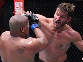 LAS VEGAS, NEVADA - AUGUST 15: In this handout image provided by UFC, Stipe Miocic (R) punches Daniel Cormier in their UFC heavyweight championship bout during the UFC 252 event at UFC APEX on August 15, 2020 in Las Vegas, Nevada.