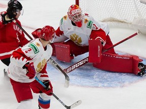 Jakob Pelletier #12 of Canada skates against Yan Kuznetsov #2 and goaltender Yaroslav Askarov #1 of Russia during the 2021 IIHF World Junior Championship semifinals at Rogers Place on January 4, 2021 in Edmonton, Canada.