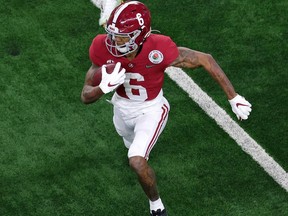 ARLINGTON, TEXAS - JANUARY 01: Wide receiver DeVonta Smith #6 of the Alabama Crimson Tide carries the football against safety Shaun Crawford #20 of the Notre Dame Fighting Irish during the second quarter of the 2021 College Football Playoff Semifinal Game at the Rose Bowl Game presented by Capital One at AT&T Stadium on January 01, 2021 in Arlington, Texas.