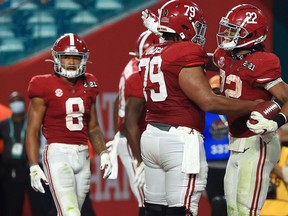 MIAMI GARDENS, FLORIDA - JANUARY 11: Najee Harris #22 of the Alabama Crimson Tide celebrates a touchdown with Chris Owens #79 during the fourth quarter of the College Football Playoff National Championship game against the Ohio State Buckeyes at Hard Rock Stadium on January 11, 2021 in Miami Gardens, Florida.