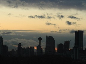 The sun sets behind the Calgary skyline on Friday, November 13, 2020 as many come to grips with new COVID-19 restriction. Some predict may see doom and gloom on the horizon while others seem to think the newest restrictions will help the extreme rise of COVID-19 cases in the city and surrounding areas. Jim Wells/Postmedia