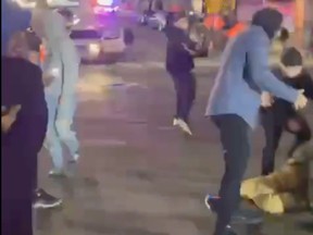A person lies on the ground after a police officer drove a vehicle into a crowd in Tacoma, Wash., Jan. 23, 2021 in this still image taken from social media video.