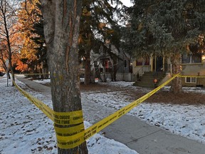 Police tape is seen around a house on 78 Avenue near 111 Street, Jan. 7, 2021. Autopsies confirm the suspicious deaths of a man and woman found in the home are the city's first two homicide of 2021.
