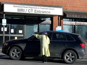 Nurses wearing PPE are seen outside the Richmond Road Diagnostic and Treatment Centre assisting patients with their COVID-19 tests. Friday, January 22, 2021.