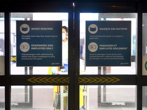 New signs are seen on the doors entering the terminal at the airport restricting access. Monday, Jan. 18, 2021.