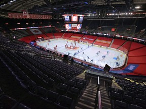 The Calgary Flames and Vancouver Canucks warm up in the empty Scotiabank Saddledome before the Flameshome opener on Jan. 16. Photo by 
Gavin Young/Postmedia.