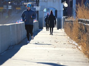 Walkers and runners enjoyed a sunny afternoon crossing the Centre Street Bridge in Calgary on Wednesday, Jan. 20, 2021.