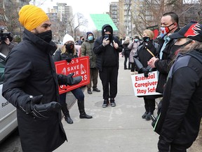 Canada's New Democratic Party (NDP) leader Jagmeet Singh speaks with protesters outside the Sienna St. George long term care home, during a rally to demand that Sienna Senior Living invest more on resident care and staff safety amid the coronavirus disease (COVID-19) outbreak, in Toronto, Ontario, Canada Jan. 10, 2021.