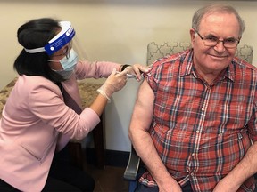 Mario Saraceni, 73, becomes the first long-term care resident in Calgary to receive the Moderna vaccine at the Mayfair Care Centre on Wednesday, Dec. 30, 2020.