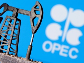 FILE PHOTO: A 3D printed oil pump jack is seen in front of displayed OPEC logo in this illustration picture, April 14, 2020.