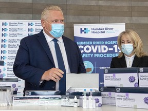 Ontario Premier Doug Ford and Long-Term Care Minister Merrilee Fullerton  are briefed on COVID-19 rapid test kits Rapid Test Device kits in Toronto on Nov. 24, 2020.