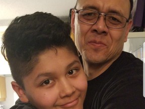 Benito Quesada hugging son, Adriel, 12