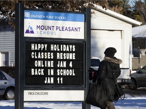 A sign outside Mount Pleasant School, 10541 60A Ave. advertises the dates for at home learning, in Edmonton Tuesday Jan. 5, 2021. Some students will return to in-school learning next week. Photo by David Bloom