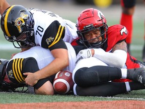 Calgary Stampeders Royce Metchie with the tackle on kicker Lirim Hajrullahu of Hamilton Tiger-Cats after the blocked kick by Tre Roberson during CFL football in Calgary on Saturday, September 14, 2019. Al Charest/Postmedia