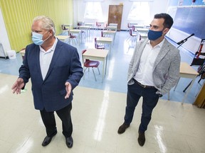 Ontario Premier Doug Ford, left, and Education Minister Stephen Lecce take a tour of Kensington Community School on Sept. 1, 2020.