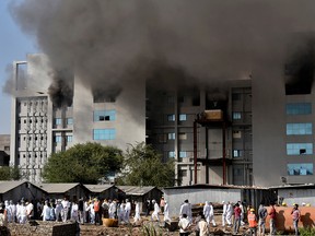 Smoke billows from a fire inside the complex of the Serum Institute of India, in Pune, India, Jan. 21, 2021.