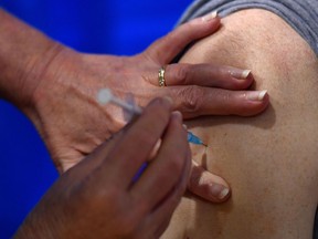 A health worker administers COVID-19 vaccine.