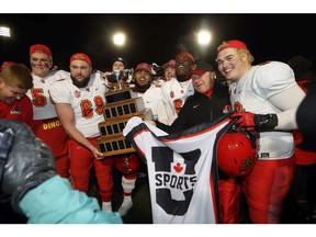 Offensive lineman Logan Bandy (69) and his Calgary Dinos teammates celebrate after winning the 2019 Vanier Cup.