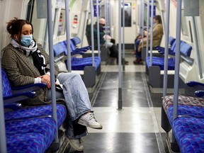 Commuters travel inside an almost empty train, amid the COVID-19 outbreak in London, Britain, Jan. 5, 2021.