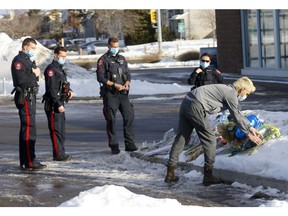 Fellow District 5 officers pay tribute as citizens continue to lay flowers at the location where Sgt. Andrew Harnett was killed Thursday night after he was struck by a fleeing vehicle at a traffic stop in Falconridge in Calgary on Sunday, January 3, 2021. Darren Makowichuk/Postmedia