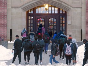Students head back to class at Crescent Heights High School in Calgary on Monday, Jan. 11, 2021.