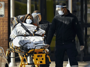 Paramedics take away a patient from Revera Westside Long Term Care Home in Toronto on Dec. 7, 2020.