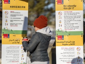 Multi-language signs posted by the city encourage physical distancing at Prairie Winds Park in northeast Calgary on Thursday, Jan. 14, 2021.