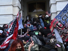 Trump supporters clash with police and security forces as they storm the US Capitol in Washington, DC on Jan. 6, 2021.