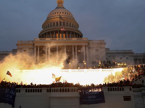 An explosion caused by a police munition is seen while supporters of U.S. President Donald Trump gather in front of the U.S. Capitol Building in Washington, U.S., Jan. 6, 2021.