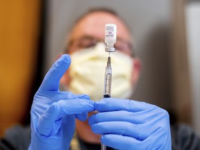 Pharmacist Brian Kiefer prepares a dose of Pfizer's COVID-19 vaccine at UC Davis Health on Tuesday, Jan. 12, 2021, in Sacramento, Calif.