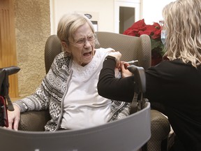 Margaret Watson, 94, receives a COVID-19 vaccine shot from paramedic Jessi Bittner at Oakview Place Long Term Care Residence in Winnipeg on Jan. 11, 2021. Watson was the first member of the public to receive the vaccine in Winnipeg.