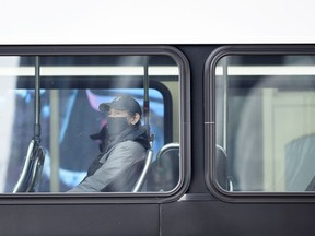 A masked passenger takes the Calgary Transit bus on Tuesday, January 12, 2021.