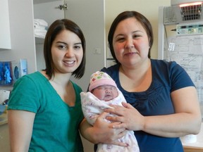 Inuit midwives Cas Augaarjuk Connelly (left) and Rachel Qiliqti Kaludjak pose after a birth at Rankin Inlet's birthing centre in 2012.