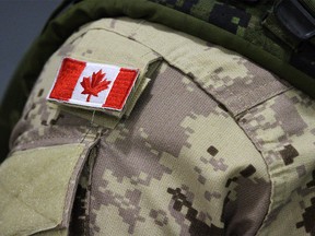 A Canadian flag sits on a member of the Canadian forces in Trenton, Ont., on Thursday, Oct. 16, 2014.