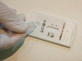A paramedic conducts a rapid antigen test at a COVID-19 testing station set up in the temporarily closed RiLANA fashion store during the coronavirus pandemic on February 3, 2021 in Berlin, Germany. Canada needs to ignore the finger pointing on vaccinations and embrace rapid testing as something we can do to reduce the spread of infections, says columnist Jim Dewald.