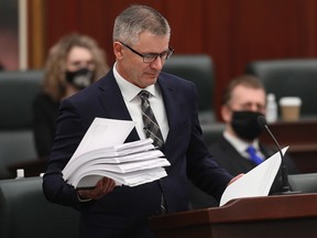 Minister of Finance Travis Toews prepares to deliver the 2021 Alberta Provincial budget at the Alberta Legislature, in Edmonton Thursday Feb. 25, 2021.