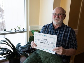 Bill Goodwin celebrates receiving his second COVID-19 vaccination at Benevolence Care Centre in Edmonton, on Thursday, Feb. 11, 2021. Goodwin is looking forward to seeing his wife of 50 years again. Photo by Ian Kucerak