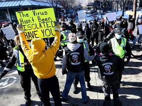 Calgary police were busy keeping peace as hundreds of anti-mask protesters and counter-protesters faced off at City Hall in Calgary on Saturday, Feb. 27, 2021.