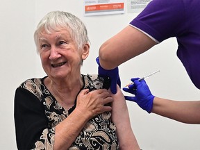 Jane Malysiak, 84, reacts as she becomes the first person in Australia to receive a dose of the Pfizer/BioNTech Covid-19 vaccine at the Castle Hill Medical Centre in Sydney on Feb. 21, 2021.
