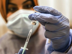 An employee of the United Nations Relief and Works Agency for Palestine Refugees (UNRWA)  prepares a shot of the Sputnik V COVID-19 vaccine for medical staff at UNRWA's al-Sheikh Redwan clinic in Gaza City, on Feb. 25, 2021.