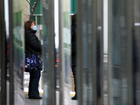 CTrain passengers wait for the next train at the 5th Street station in downtown Calgary on Tuesday, Feb. 23, 2021.