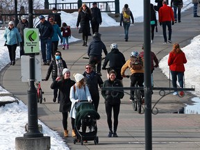 Calgarians enjoy a sunny warm afternoon for some exercise along the Bow River pathway on Sunday, Feb. 28, 2021.