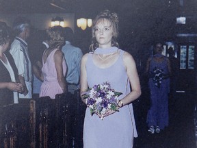 Murder victim Tara Landgraf walks the aisle as a bridesmaid in her sister Lisa's wedding in this family photo.