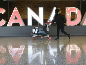 Passengers arrive at the Calgary International Airport on Monday, Feb. 1, 2021.