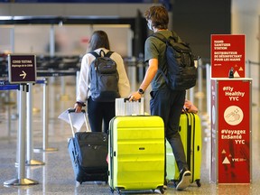 Passengers arrive at the Calgary International Airport from Cancun on Monday, Feb. 1, 2021.