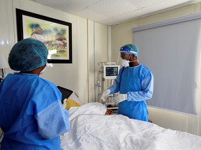 FILE PHOTO: Doctors attend to a COVID-19 patient at EHA Clinics in Abuja, Nigeria, Jan. 14, 2021.