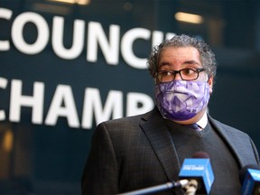 Mayor Naheed Nenshi speaks to reporters outside council chambers in City Hall.