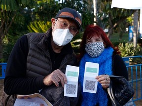 Israelis shows their "green pass" (proof of being fully vaccinated against the coronavirus) before entering the Green Pass concert for vaccinated seniors, organised by the municipality of Tel Aviv, on February 24, 2021. - Israel recently took a step towards normalcy, re-opening a raft of businesses and services from pandemic lockdowns, but with some only available to fully vaccinated "green pass" holders. 

Nearly three million people, almost a third of Israel's population, have received the two recommended doses of the Pfizer/BioNTech coronavirus vaccine, the world's quickest inoculation pace per capita.
