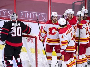 CP-Web.  Ottawa Senators goaltender Matt Murray (30) stands in his crease as Calgary Flames left wing Andrew Mangiapane (88), left to right, defenceman Rasmus Andersson (4), Matthew Tkachuk (19), Mikael Backlund (11) and Mark Giordano (5) celebrate a goal during second period NHL action in Ottawa on Saturday, Feb. 27, 2021.